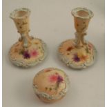A pair of Grainger's Worcester blush ivory dressing table candlesticks, decorated with flowers and a