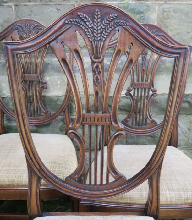 A set of four reproduction mahogany dining chairs, with carved shield backs and drop in seats - Image 2 of 2