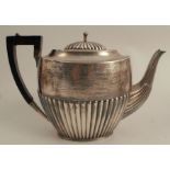 A silver teapot, of oval form with gadrooned lower body and presentation inscription, Sheffield