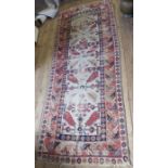An Eastern design runner, af, 104ins x 40ins, together with a red ground mat, 37ins x 24ins