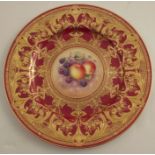A Royal Worcester cabinet plate, decorated with fruit to the centre by P Lynes, with burgundy and
