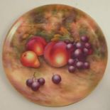 A Royal Worcester plate, decorated with fruit to a mossy background by E Townsend, diameter 9.