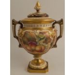 A Royal Worcester covered vase, raised on a pedestal and decorated all round with hand painted fruit