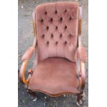 A 19th century mahogany and upholstered easy chair, with button back and scroll arms, raised on