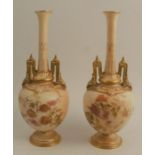 A pair of Royal Worcester blush ivory vases, decorated with flowers, on a pedestal foot, shape
