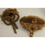 Two gilded wall shelves, one decorated with knotted rope, the other with floral garlands, widths