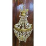 A gilt metal and glass chandelier light fitting, having tiered droppers