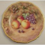 A Royal Worcester cabinet plate, decorated with fruit to a mossy background by Freeman, with