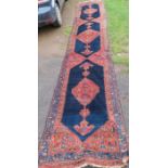 An Eastern design runner,  with red and blue ground, 225ins x 37.5ins