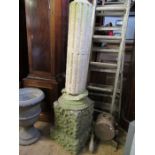 A stone garden column on a plinth, af