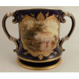 A Royal Worcester two handled mug, of waisted form decorated with a blue ground reserving a panel