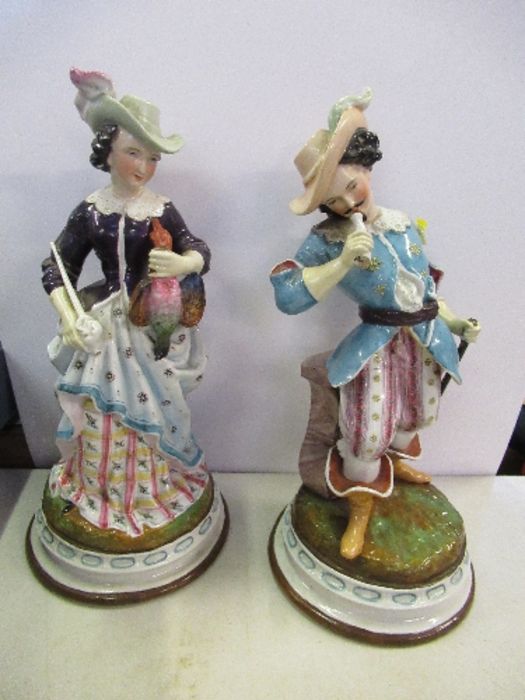 A pair of continental figures, of a man and a lady in period dress