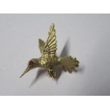 A small hummingbird brooch, stamped '14K', with ruby set eye, 2.8g gross