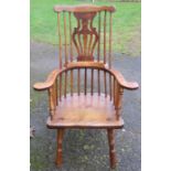 A 19th century elm and beech broad armed high splat back Windsor chair, raised on turned legs