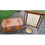 A leather covered travelling trunk, together with a mahogany framed fire screen with tapestry