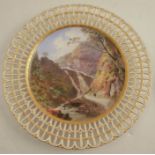 A Minton porcelain cabinet plate, with pierced border, the centre decorated with a named view of