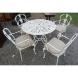 A painted metal circular garden table, and four chairs with pierced decoration, diameter of table
