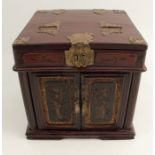 An Oriental table top wooden cabinet, with carved decoration, the hinged lid with mirror, fitted