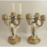 A pair of 19th century Minton porcelain candelabra, with three lights each, supported by three