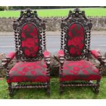 A pair of Antique carved oak hall chairs, heavily carved with lions, scrolls and leaves, with barley