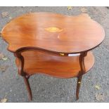 An Edwardian mahogany occasional table, of shaped oval form, with inlaid shell and chequer band,