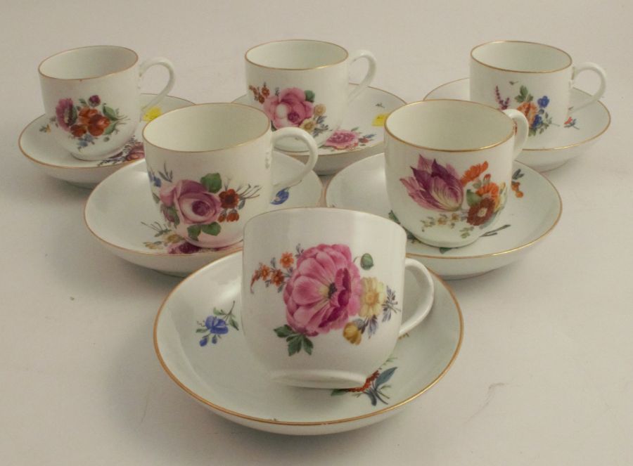 A set of six Meissen porcelain cups and saucers, decorated with flowers, crossed swords mark to