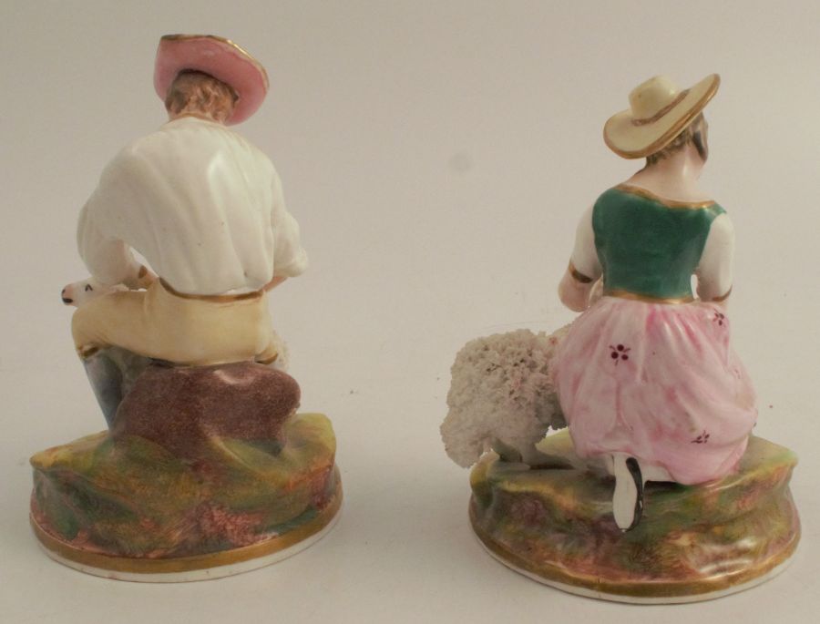 A pair of continental figures, of a man and woman seated with sheep, af, both height 5ins - Image 2 of 3