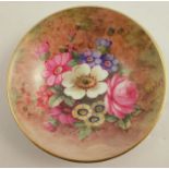 A Royal Worcester circular dish, decorated with flowers by E Barker, diameter 2.75ins - very crazed