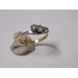 A gold crossover three stone diamond ring, finger size M