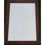 An oak framed wall mirror, of rectangular form with carved decoration to the frame, overall size