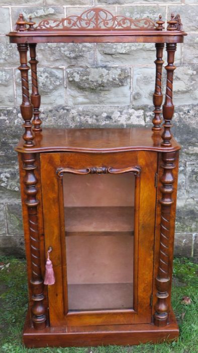 A Victorian walnut cabinet, with shelf having pierced gallery to three sides, raised on turned