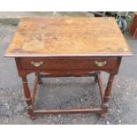 A 17th century single drawer oak side table, having a shaped frieze, standing on bluster turned legs