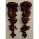 A pair of carved wooden wall shelves, decorated with flowers and leaves, height 10.75ins, width