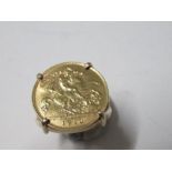 A gold 1910 half sovereign ring in yellow metal mount