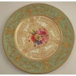 A Royal Worcester cabinet plate, decorated with flowers to the centre by Higgins, with green and
