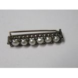 A Victorian six pearl line brooch, with rose cut diamonds in between, 3.6cm long