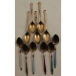 A set of six silver gilt and enamel coffee spoons, together with a set of silver gilt coffee spoons