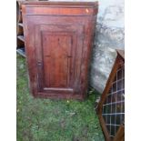 An Antique oak corner cupboard, with inlaid decoration to the door, height 45.5ins, width 27.5ins,