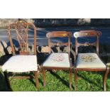 A pair of Regency mahogany dining chairs, together with another dining chair