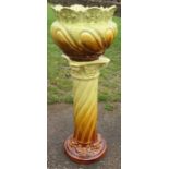 A Woodlesford Art Pottery Leeds jardiniere and stand, decorated in yellow and brown with masks and