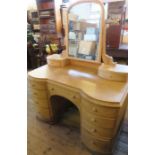 A pine dressing table, with mirror and two jewellery drawers to the back, the table fitted with an