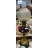 An oil lamp, with ruby glass reserve and brass column