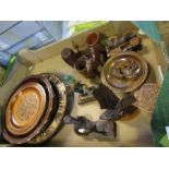 A collection of carved wooden plates, boxes, animals and figures