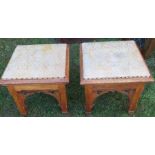 A pair of gothic style oak stools, with square section legs, united by fret cut arches, width 17ins