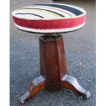 A 19th century piano stool, raised on an inverted graduated hexagonal base, terminating in three paw
