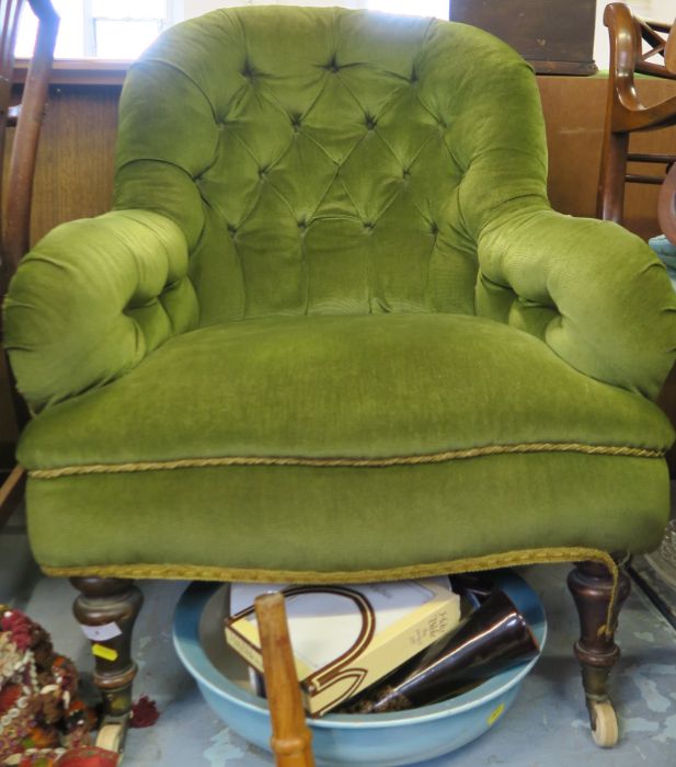 An Edwardian deep button back easy chair