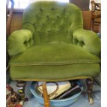 An Edwardian deep button back easy chair