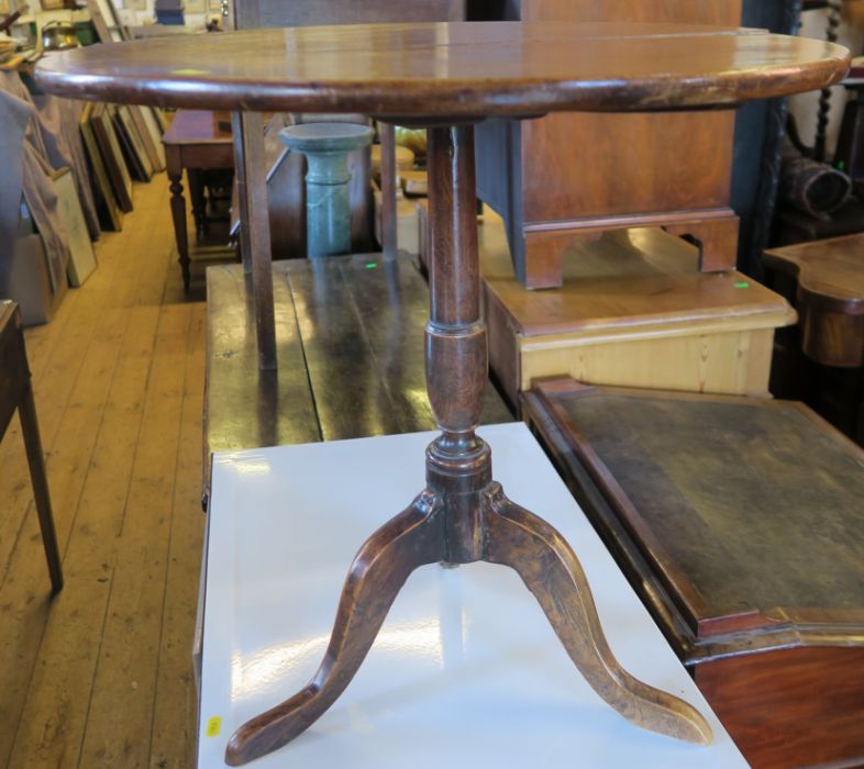 An Antique mahogany topped table, on an elm tripod base, diameter 23ins, height 23ins