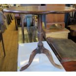 An Antique mahogany topped table, on an elm tripod base, diameter 23ins, height 23ins