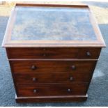 A 19th century mahogany desk, with sloping writing surface, over six drawers, raised on a plinth